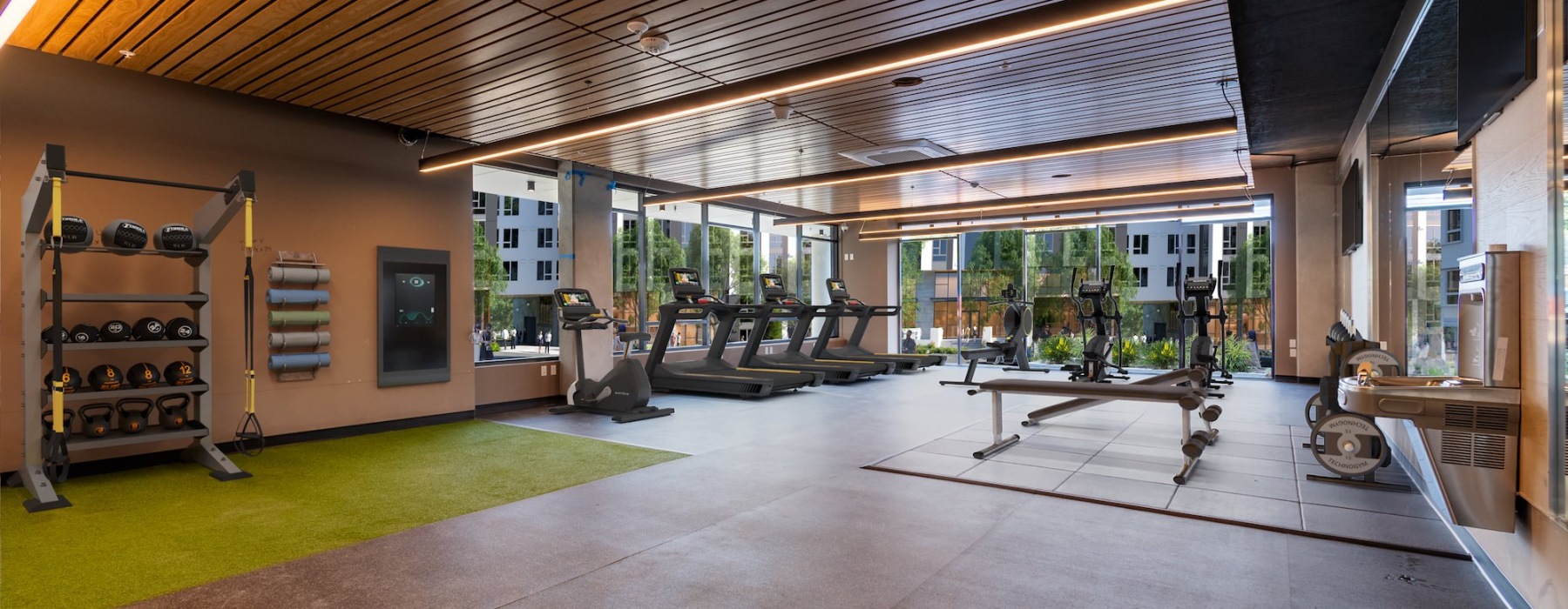 fitness studio with exercise equipment and large windows