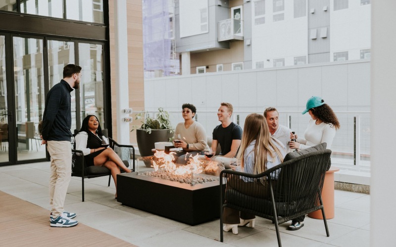 a group of people sitting by a fire pit