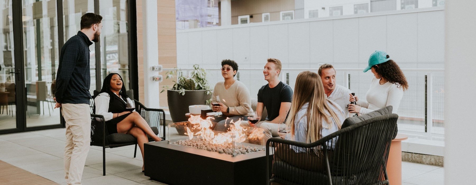 a group of people sitting by a fire pit