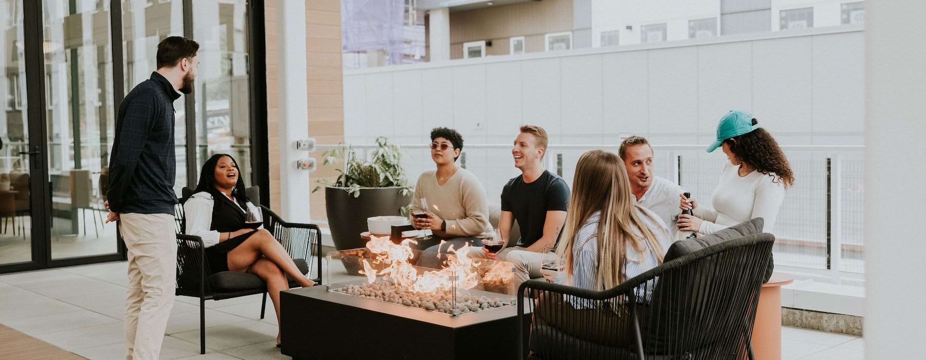 a group of people sitting by a fire pit