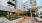 outdoor area with seating tables and tall building behind them. 