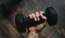 a person's hand holding a dumbbell