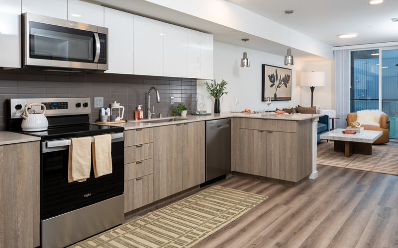 kitchen with ample lighting open to living room