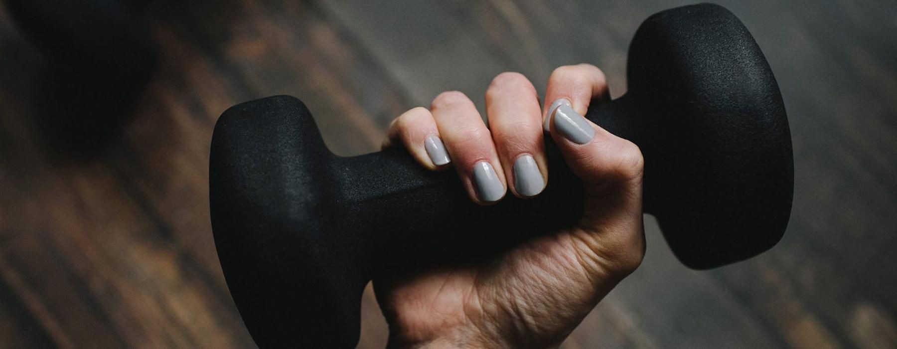 a person's hand holding a dumbbell